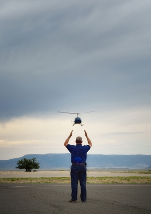 Ty Clinesmith signals helicopter landing at Raton Municipal Airport