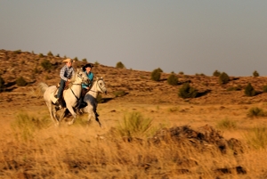 Marcia Hefker and son Cy Brower ride their Hindi Arabian horses near Des Moines, NM