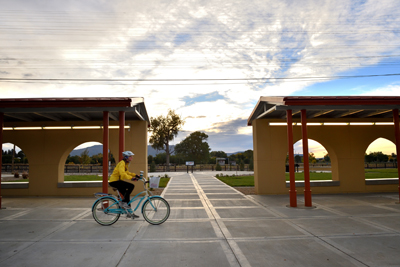 Sunrise bicyclist at Raton depot, by Tim Keller