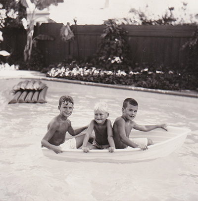 1950s summer swimming pool fun, boys in boat