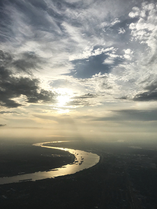 The Mississippi River enters New Orleans at sundown, aerial photo by Tim Keller