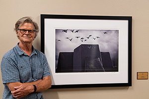Photographer Tim Keller with his new installation "Alight" at Taos Senior Center, July 2020.