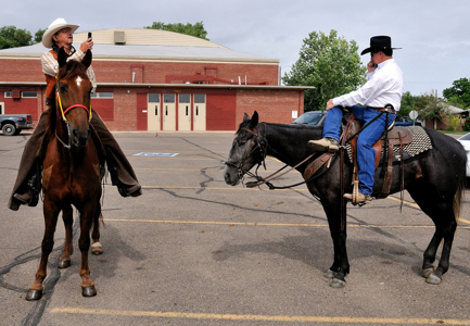cell phones on horseback, Swink, Colorado, parade